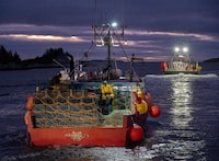Lobster boats, loaded with pots and buoys, head from West Dover, N.S. on Tuesday, Nov. 29, 2022 for the opening of the season in Lobster Fishing Area 33. THE CANADIAN PRESS/Andrew Vaughan