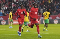 Canada's Alphonso Davies (19) celebrates scoring his team's opening goal against  Jamaica with Jonathan David (20) during first half CONCACAF Nations League quarterfinals action in Toronto, on Tuesday, November 21, 2023.THE CANADIAN PRESS/Chris Young
