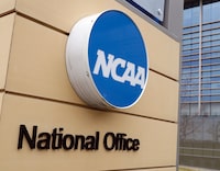 FILE - Signage at the headquarters of the NCAA is viewed in Indianapolis, March 12, 2020. An NCAA medical committee believes it is time to remove marijuana from the governing body's list of banned drugs. It also thinks drug testing should be limited to performance-enhancing substances. (AP Photo/Michael Conroy, File)