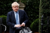 FILE PHOTO: Former British Prime Minister Boris Johnson walks outside his home, in London, Britain, March 22, 2023. REUTERS/Peter Nicholls/File photo