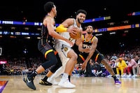 Denver Nuggets guard Jamal Murray, center, is pressured by Phoenix Suns guard Landry Shamet, left, and guard Cameron Payne during the second half of Game 4 of an NBA basketball Western Conference semifinal game, Sunday, May 7, 2023, in Phoenix. The Suns defeated the Nuggets 129-124. (AP Photo/Matt York)