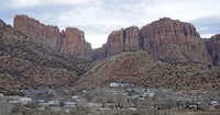 FILE - This photo shows Hildale, Utah, sitting at the base of Red Rock Cliff mountains, with its sister city, Colorado City, Ariz., in the foreground, Dec. 16, 2014. The guilty plea of Samuel Bateman, the leader of a polygamous sect in the Colorado City-Hildale area who is accused in a scheme to orchestrate sexual acts involving children, is at risk of being thrown out due to an unmet condition of his plea deal that hinged on whether other charged in the case also would plead guilty. Prosecutors informed the court, Thursday, April 11, 2024, that two other men charged in the case had rejected plea offers. (AP Photo/Rick Bowmer, File)
