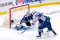 May 10, 2024; Vancouver, British Columbia, CAN; Vancouver Canucks forward Ilya Mikheyev (65) watches as Edmonton Oilers forward Connor McDavid (97) scores on goalie Arturs Silvos (31) during the third period in game two of the second round of the 2024 Stanley Cup Playoffs at Rogers Arena. Mandatory Credit: Bob Frid-USA TODAY Sports