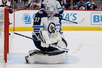 Apr 13, 2024; Denver, Colorado, USA; Winnipeg Jets goaltender Connor Hellebuyck (37) makes a save in the second period against the Colorado Avalanche at Ball Arena. Mandatory Credit: Isaiah J. Downing-USA TODAY Sports