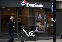 A person walks past a Domino's pizza restuarant in London, Britain, March 4, 2023. REUTERS/Henry Nicholls/ File photo