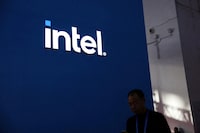 FILE PHOTO: A man walks past the Intel logo at its booth during the first China International Supply Chain Expo (CISCE) in Beijing, China November 28, 2023. REUTERS/Florence Lo/File Photo
