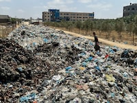 A Palestinian man walks on piles of garbage, amid the ongoing conflict in Gaza between Israel and Hamas, at Deir Al-Balah, in the central Gaza Strip, May 2, 2024. REUTERS/Doaa Rouqa     TPX IMAGES OF THE DAY