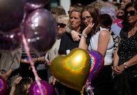 FILE - People hold a minute of silence in a square in central Manchester, England, on May 25, 2017, after a suicide bombing attack at an Ariana Grande concert at the Manchester Arena. Britain's domestic intelligence agency didn't act swiftly enough on key information and missed a significant opportunity to prevent the suicide bombing that killed 22 people at a 2017 Ariana Grande concert, an inquiry found Thursday, March 2, 2023. (AP Photo/Emilio Morenatti, File)