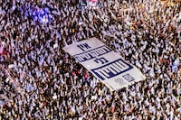 FILE PHOTO: Israelis take part in a demonstration against Israeli Prime Minister Benjamin Netanyahu and his nationalist coalition government's judicial overhaul, in Tel Aviv, Israel September 2, 2023. Banner in Hebrew reads, "No Democracy without Equality".  REUTERS/Oren Alon/File Photo