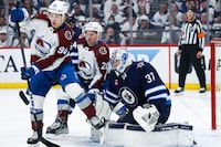 Apr 23, 2024; Winnipeg, Manitoba, CAN; Colorado Avalanche forward Joel Kiviranta (94) and forward Ross Colton (20) attempt to get in front of Winnipeg Jets goalie Connor Hellebuyck (37) during the first period in game two of the first round of the 2024 Stanley Cup Playoffs at Canada Life Centre. Mandatory Credit: Terrence Lee-USA TODAY Sports