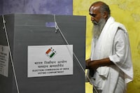 A Sadhu or Hindu holy man casts his ballot at a polling station during the second phase of voting of India's general elections in Vrindavan on April 26, 2024. (Photo by Money SHARMA / AFP) (Photo by MONEY SHARMA/AFP via Getty Images)