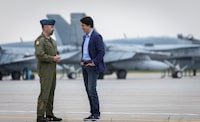 Canada's Prime Minister Justin Trudeau speaks with Colonel Colin Marks, before a briefing on wildfire fighting efforts from Canadian Forces personnel, in Bagotville, Quebec, Canada June 14, 2023.  REUTERS/Pascal Ratthe NO RESALES. NO ARCHIVES.