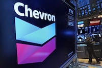 FILE - The logo for Chevron appears above a trading post on the floor of the New York Stock Exchange on Nov. 1, 2021. Shares of Chevron climbed Thursday, Jan. 26, 2023, after the oil company announced that it would repurchase $75 billion of its stock, one of the largest-ever stock buyback plans. (AP Photo/Richard Drew, File)