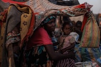 ADRE, CHAD - APRIL 19: Zahra Tarreel Adam, 19, and her 1 Year old Abdallah who fled from their village of Kandobe in Darfur, Sudan, on April 19, 2024 in Adre, Chad. Since the beginning of the recent conflict between the paramilitary Rapid Support Forces (RSF) and the the Sudanese Armed Forces, (SAF), which began in March 2023, over 600,000 new refugees have crossed the border from Darfur in Sudan, into Chad. The total number of refugees, including those from previous conflicts, now stands at 1.2 million. Aid agencies, including The World Food Programme, (WFP), Médecins Sans Frontières (MSF) and the United Nations High Commissioner for Refugees, (UNHCR), already struggling with accute supply shortages, have warned that the life-saving programmes in Chad, will ‘grind to a halt in a matter of weeks without urgent funding’. Chad is now home to one of the largest and fastest-growing refugee populations in Africa.  (Photo by Dan Kitwood/Getty Images)