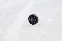A hockey puck is seen during a break in play between the Chicago Blackhawks and the New Jersey Devils during the first period of an NHL hockey game Friday, Jan. 5, 2024, in Newark, N.J. (AP Photo/Adam Hunger)