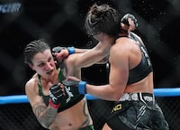 Raquel Pennington, left, fights Mayra Bueno Silva during a women's bantamweight title bout at UFC 297 in Toronto on Sunday, January 21, 2024. THE CANADIAN PRESS/Nathan Denette