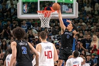 Dallas Mavericks guard Josh Green (8) slam dunks an alley oop from Mavericks' guard Luka Doncic, not pictured, over Los Angeles Clippers guard Norman Powell (24) as Clippers' center Ivica Zubac (40) and Mavericks' center Dereck Lively II (2) look on during the first half of Game 6 of an NBA basketball first-round playoff series Friday, May 3, 2024, in Dallas. (AP Photo/Jeffrey McWhorter)