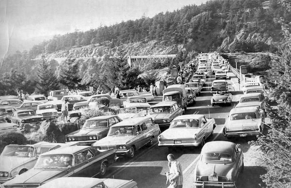 On July 29, 1965, onlookers crowded Deception Pass bridge to witness transportation of the orca known as “Namu” from the waters of British Columbia to Seattle Marine Aquarium.  Aquarium owner Ted Griffin, together with his partner Don Goldsberry, would later orchestrate a number of whale captures in the Puget Sound, the largest being in Penn Cove in August 1970. Credit: Wallie V. Funk / Western Libraries Archives & Special Collections