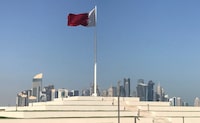 FILE PHOTO: The Qatari flag is seen at a park near Doha Corniche, in Doha, Qatar February 17, 2018. Picture taken February 17, 2018. REUTERS/Ibraheem al Omari