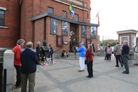 Guests arriving to the Orillia Opera House stop to take pictures with the bust of Gordon Lightfoot before attending a sold out memorial concert for Lightfoot at the Opera House, in Orillia, Ont., Saturday, May 6, 2023. The show, titled “Early Morning Rain: The Legend of Gordon Lightfoot”, served as a celebration of life after the famed musician died May 1st at the age of 84. THE CANADIAN PRESS/Christopher Drost