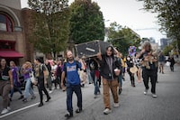 Andrew Leavens, front left, and Carl Gladue, front right, carry an empty coffin during a march organized by the Vancouver Area Network of Drug Users (VANDU) to mark International Overdose Awareness Day, in Vancouver, on Thursday, August 31, 2023. More than 12,000 lives have been lost to illicit drugs since the province declared a public health emergency in April 2016. THE CANADIAN PRESS/Darryl Dyck