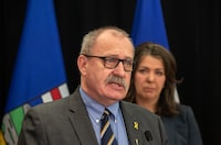 Minister of Municipal Affairs Ric McIver and Alberta Premier Danielle Smith take part in a press conference in Edmonton on Wednesday April 10, 2024. THE CANADIAN PRESS/Jason Franson