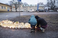 People bring candles and flowers at the Viertola school in Vantaa, Finland, on April 2, 2024. REUTERS/ File photo