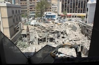 An excavator clears rubble after a suspected Israeli strike on Monday on Iran's consulate, adjacent to the main Iranian embassy building, which Iran said had killed seven military personnel including two key figures in the Quds Force, in the Syrian capital Damascus, Syria April 2, 2024. REUTERS/Firas Makdesi/File Photo