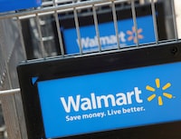 FILE PHOTO: Shopping carts are seen outside a new Walmart Express store in Chicago July 26, 2011. REUTERS/John Gress