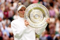 LONDON, ENGLAND - JULY 15: Marketa Vondrousova of Czech Republic kisses the Women's Singles Trophy as she celebrates victory following the Women's Singles Final against Ons Jabeur of Tunisia on day thirteen of The Championships Wimbledon 2023 at All England Lawn Tennis and Croquet Club on July 15, 2023 in London, England. (Photo by Clive Brunskill/Getty Images)