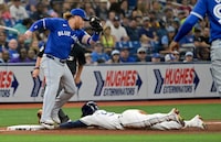 Toronto Blue Jays' Justin Turner, left, is late with the tag as Tampa Bay Rays' Randy Arozarena steals third base during the seventh inning of a baseball game Saturday, March 30, 2024, in St. Petersburg, Fla. (AP Photo/Steve Nesius)