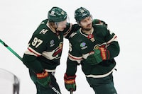 Minnesota Wild left wing Kirill Kaprizov (97) celebrates with right wing Mats Zuccarello (36) after Zuccarello scored a goal against the Dallas Stars during the third period of Game 3 of an NHL hockey Stanley Cup first-round playoff series Friday, April 21, 2023, in St. Paul, Minn. The Wild won 5-1. (AP Photo/Stacy Bengs)