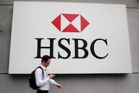 FILE PHOTO: A man walks past a logo of HSBC at its headquarters in Kuala Lumpur, Malaysia August 6, 2019. Picture taken August 6, 2019. REUTERS/Lim Huey Teng/File Photo