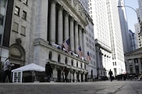 People pass the front of the New York Stock Exchange in New York, Tuesday, March 21.
