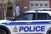 An Ottawa Police officer enters a home, the scene of a homicide where six people were found dead, in Ottawa, Thursday, March 7, 2024. The 19-year-old charged with killing six people in an<div>Ottawa suburb last week is being held in protective custody, his lawyer said. THE CANADIAN PRESS/Adrian Wyld</div>