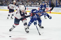 Columbus Blue Jackets right wing Justin Danforth (17) fans on the shot as Toronto Maple Leafs' Morgan Rielly (44) defends during third period NHL hockey action in Toronto on Thursday, December 14, 2023. THE CANADIAN PRESS/Nathan Detente