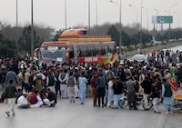 Supporters of Pakistani former Prime Minister Imran Khan's party, the Pakistan Tehreek-e-Insaf (PTI), block the Peshawar-Islamabad motorway as part of their protest against the results of the general election, in Peshawar, Pakistan, February 12, 2024. REUTERS/Fayaz Aziz
