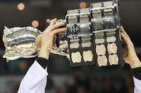 The Memorial Cup is lifted after the Edmonton Oil Kings beat the Guelph Storm in the championship game of the Memorial Cup CHL hockey tournament in London, Ont., on Sunday, May 25, 2014. After the CHL and its regional leagues cancelled the playoffs and the Memorial Cup last week, coaches across the country are left to ponder what could have been. THE CANADIAN PRESS/Dave Chidley