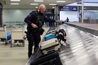 Canada Border Services Agency (CBSA) detector dog handler Todd Fulton and his dog Shakira demonstrate a search for contraband at Ottawa International Airport March 26, 2024 in Ottawa.  Dave Chan/The Globe and Mail