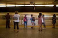 Commuters wait to take the subway at Christie Station in Toronto on Friday, June 22, 2018. Transit riders in Toronto will be able to use their credit or debit card including cards on a smartphone or smartwatch to pay for their trips' fares starting on Tuesday. THE CANADIAN PRESS/ Tijana Martin