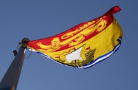 New Brunswick's provincial flag flies on a flag pole in Ottawa, Monday July 6, 2020. Police say a man has died after a fire at an encampment in Saint John, N.B. Local police say emergency crews responded to the fire near the viaduct at a highway on-ramp on Saturday night.THE CANADIAN PRESS/Adrian Wyld