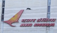 FILE PHOTO: A bird flies over a logo of Air India airlines at the corporate headquarters in Mumbai, India, October 19, 2021. REUTERS/Francis Mascarenhas/File Photo