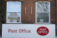 FILE = A post office logo on a shop front on a street in London, on Jan. 16, 2024. The British government will introduce legislation Wednesday, March 13, 2024, to quash the wrongful convictions of hundreds of Post Office branch managers in England and Wales who were caught up in one of the U.K.'s biggest miscarriages of justice. Prime Minister Rishi Sunak said the legislation “marks an important step forward in finally clearing” the names of those who were convicted on the basis of a faulty computer accounting system, known as Horizon, and have faced long delays in having their compensation claims assessed. (AP Photo/Frank Augstein)