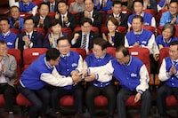 South Korea's main opposition Democratic Party (DP) leader Lee Jae-myung, third right, and candidates, watch TV broadcasting results of exit polls for the parliamentary election at the National Assembly on Wednesday, April 10, 2024 in Seoul, South Korea. (Chung Sung-Jun/Pool Photos via AP)