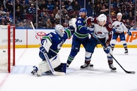Colorado Avalanche's Nathan MacKinnon, not seen, scores on Vancouver Canucks goaltender Casey DeSmith (29) as Ian Cole (82) and Colorado's Valeri Nichushkin (13) watch during NHL overtime action in Vancouver, Wednesday, March 13, 2024. THE CANADIAN PRESS/Ethan Cairns
 