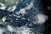 This satellite image provided by the National Oceanographic and Atmospheric Administration shows Hurricane Lee, right, in the Atlantic Ocean on Friday, Sept. 8, 2023, at 4:50 p.m. EDT. Though the track of hurricane Lee remains unclear, anxiety created by powerful storms is a growing reality on the East Coast — especially in communities that felt Fiona's wrath last year. THE CANADIAN PRESS/AP-NOAA via AP