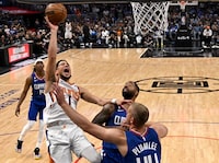 Apr 20, 2023; Los Angeles, California, USA; Phoenix Suns guard Devin Booker (1) drives past Los Angeles Clippers forward Marcus Morris Sr. (8) and center Mason Plumlee (44) for a basket in the first half at Crypto.com Arena. Mandatory Credit: Jayne Kamin-Oncea-USA TODAY Sports