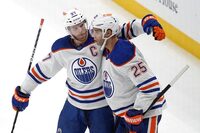 Edmonton Oilers' Darnell Nurse (25) celebrates with Connor McDavid after scoring the first of two third period goals in an NHL hockey game against the Pittsburgh Penguins in Pittsburgh, Sunday, March 10, 2024. The Oilers won 4-0. (AP Photo/Gene J. Puskar)