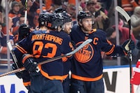 Edmonton Oilers' Ryan Nugent-Hopkins (93), Leon Draisaitl (29) and Connor McDavid (97) celebrate a goal against the Seattle Kraken during second period NHL action in Edmonton on Thursday January 18, 2024.THE CANADIAN PRESS/Jason Franson 