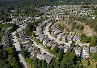Houses are seen in a neighbourhood on the side of a mountain, in Maple Ridge, B.C., on Thursday, August 17, 2023. THE CANADIAN PRESS/Darryl Dyck